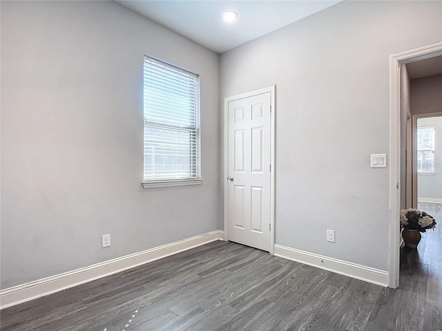 empty room with dark wood-type flooring