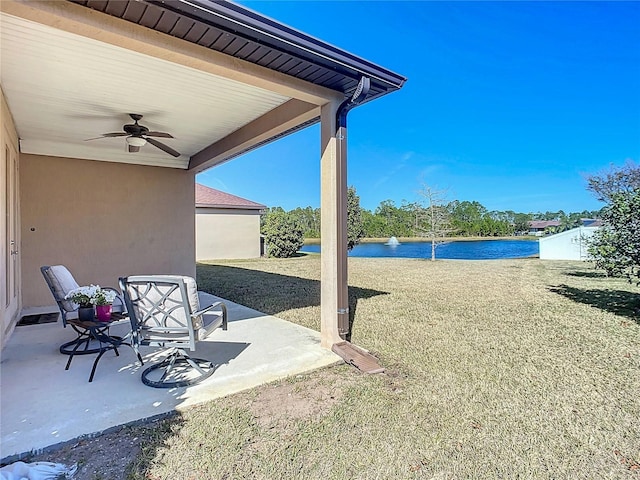 view of patio / terrace featuring a water view and ceiling fan