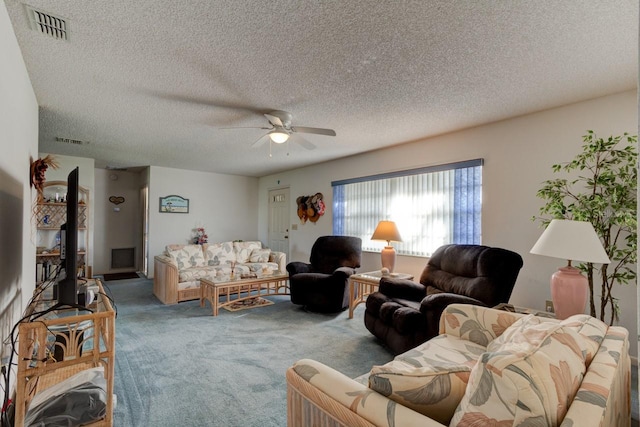 carpeted living room featuring ceiling fan, a textured ceiling, and a wood stove