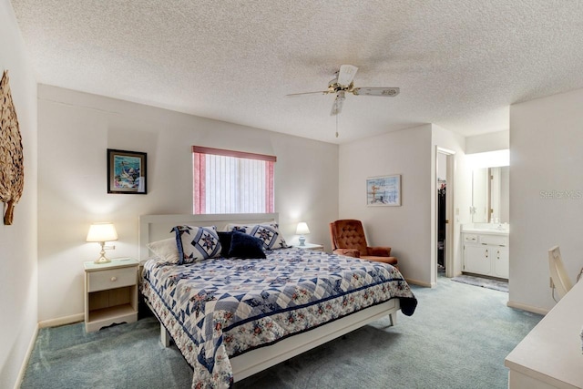 carpeted bedroom featuring ceiling fan, ensuite bath, a closet, and a textured ceiling