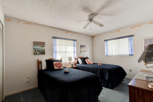 bedroom with dark carpet, a textured ceiling, and ceiling fan