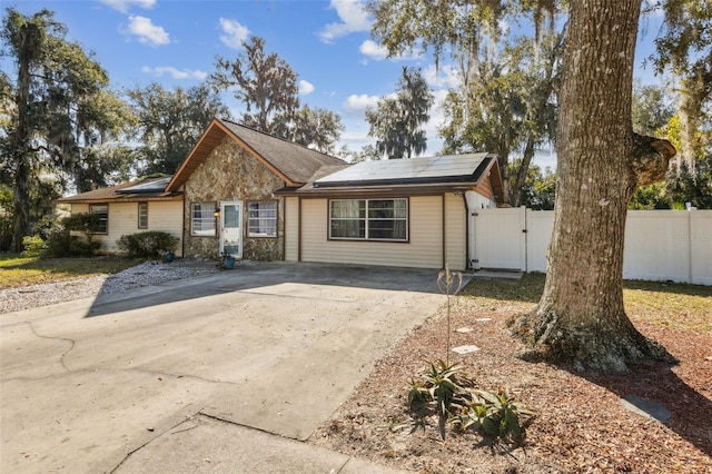 ranch-style home with solar panels