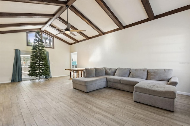 living room with beamed ceiling, ceiling fan, and high vaulted ceiling