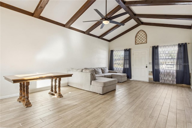 living room with beam ceiling, plenty of natural light, high vaulted ceiling, and ceiling fan