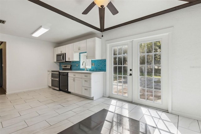 kitchen featuring french doors, sink, white cabinetry, tasteful backsplash, and appliances with stainless steel finishes