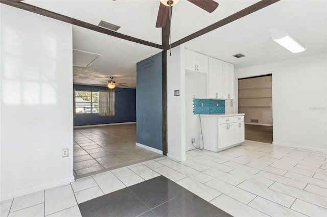 tiled spare room with ceiling fan