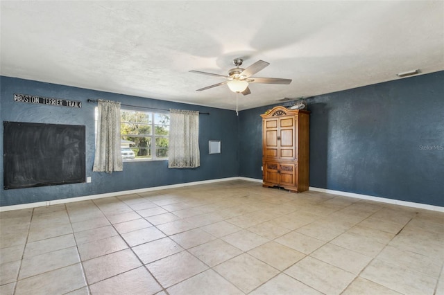 unfurnished room with ceiling fan and light tile patterned floors