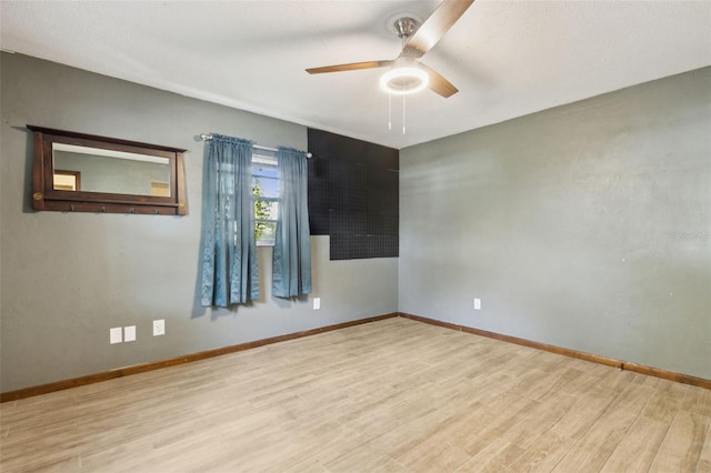 unfurnished room featuring ceiling fan and light hardwood / wood-style floors