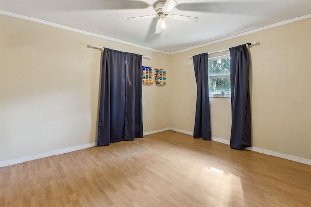 spare room featuring ornamental molding, ceiling fan, and light wood-type flooring