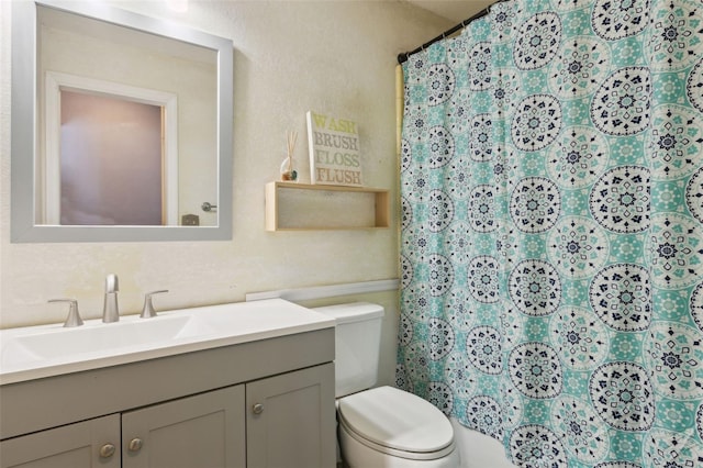 bathroom with vanity, toilet, and a shower with shower curtain