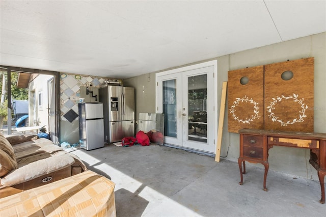 interior space featuring french doors and concrete floors