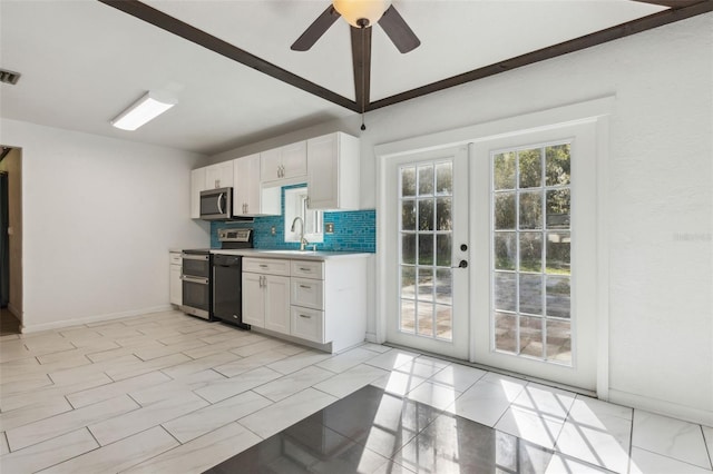 1240 W Voorhis Ave, Deland, FL 32720 - kitchen with tasteful backsplash, appliances with stainless steel finishes, light countertops, white cabinets, and a sink