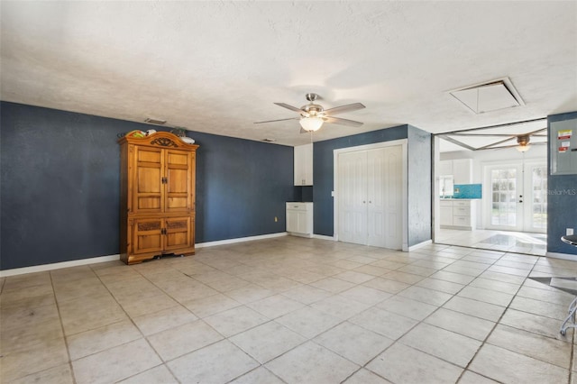 1240 W Voorhis Ave, Deland, FL 32720 - unfurnished bedroom with attic access, light tile patterned floors, a closet, a ceiling fan, and baseboards