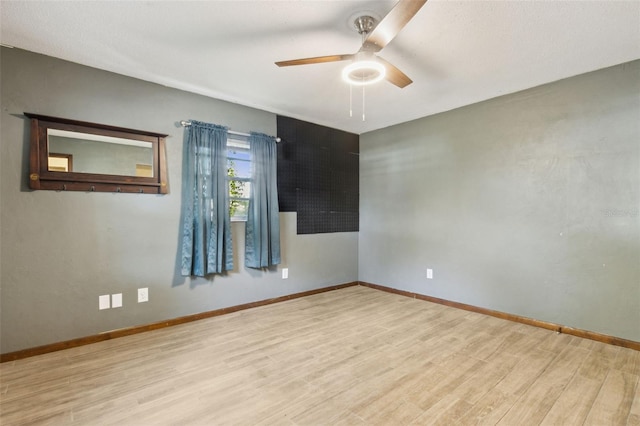 1240 W Voorhis Ave, Deland, FL 32720 - empty room with wood finished floors, a ceiling fan, and baseboards