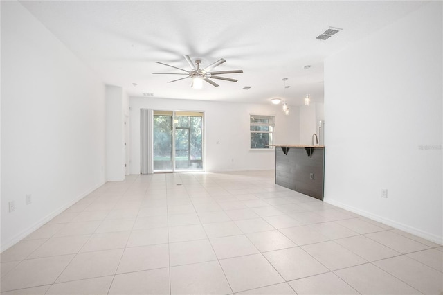 tiled spare room featuring ceiling fan