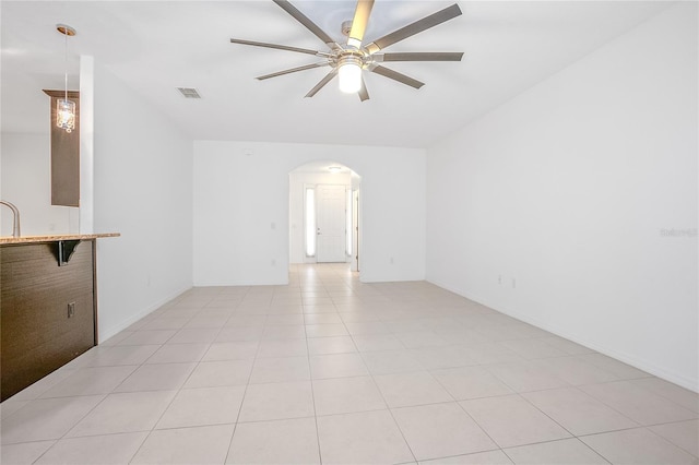 unfurnished living room with light tile patterned flooring and ceiling fan