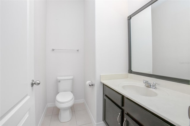 bathroom featuring tile patterned flooring, vanity, and toilet