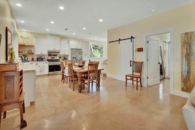 dining room featuring sink and a barn door