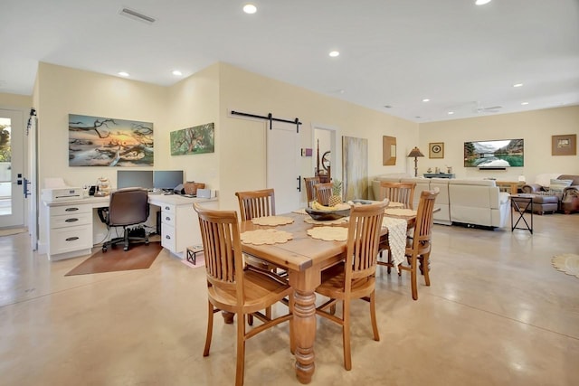 dining space featuring a barn door