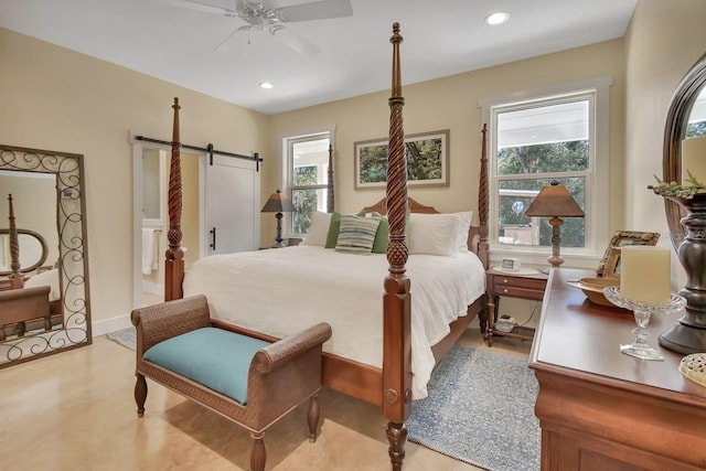 bedroom featuring a barn door and ceiling fan