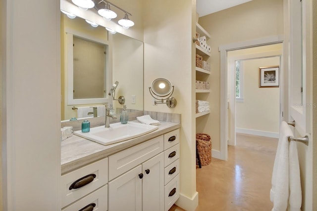 bathroom with vanity, built in features, and concrete floors