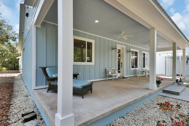 back of property with ceiling fan and covered porch