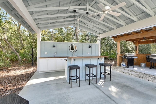 view of patio with a grill, a gazebo, an outdoor bar, and ceiling fan