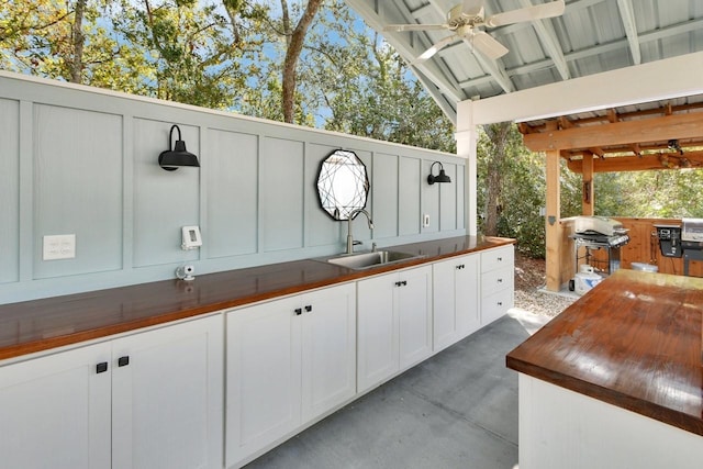 view of patio / terrace featuring ceiling fan, a grill, sink, and area for grilling