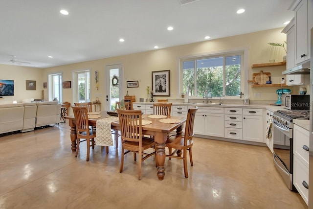 dining space with ceiling fan, plenty of natural light, and sink