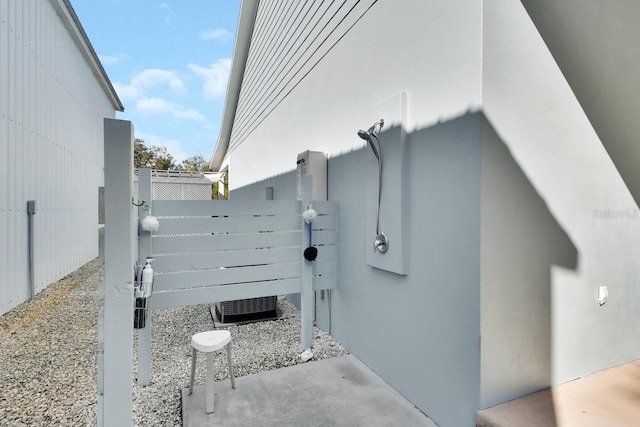 view of side of home featuring central AC unit