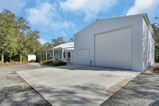 view of side of home featuring covered porch and an outdoor structure