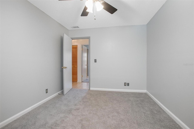 carpeted empty room with ceiling fan