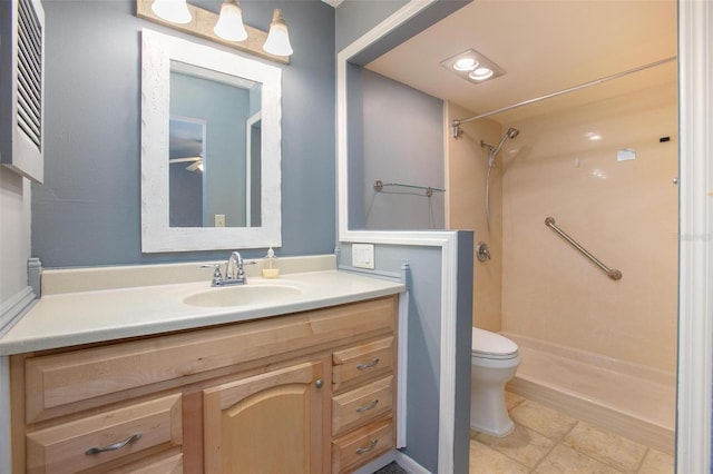 bathroom with toilet, vanity, and walk in shower