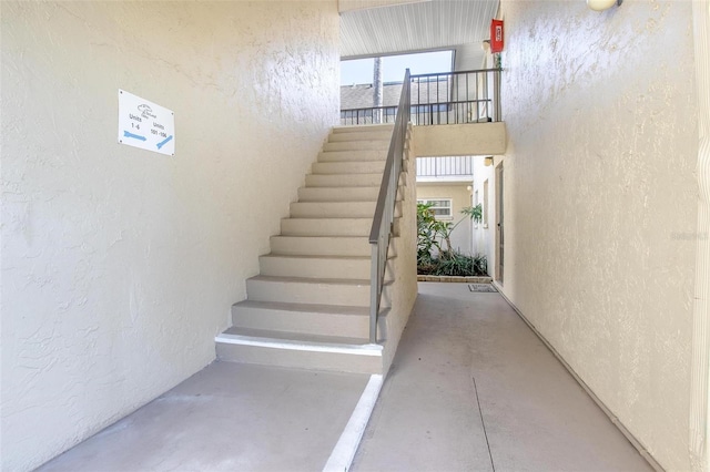 staircase with concrete flooring