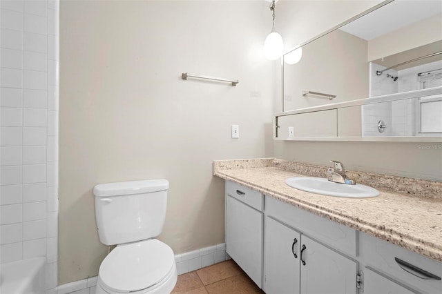 bathroom featuring tile patterned flooring, vanity, and toilet