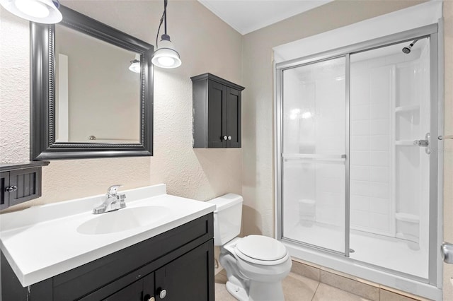 bathroom with tile patterned floors, vanity, toilet, and an enclosed shower