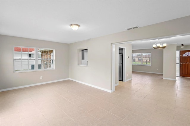 empty room with an inviting chandelier