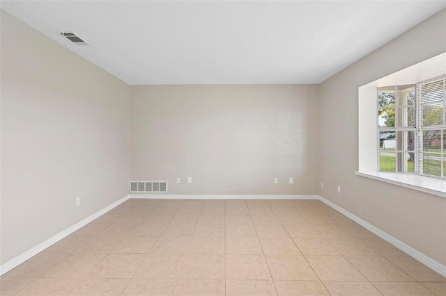 spare room featuring light tile patterned floors