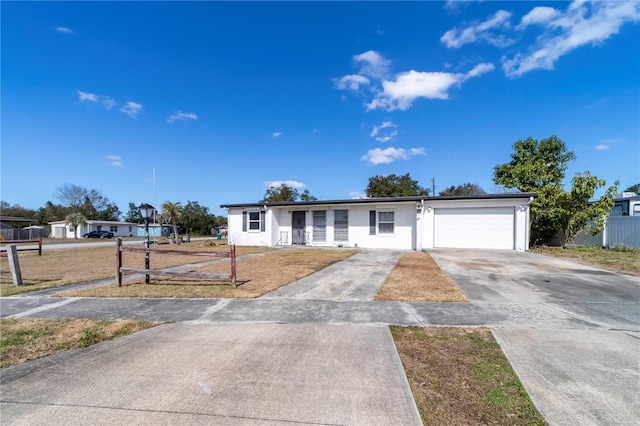 ranch-style house featuring a garage and a front lawn