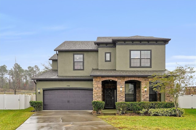 view of front of home with a garage and a front yard