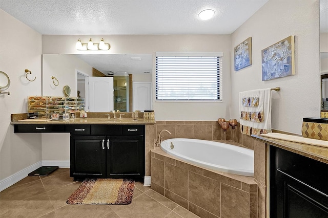 bathroom featuring tile patterned flooring, vanity, independent shower and bath, and a textured ceiling