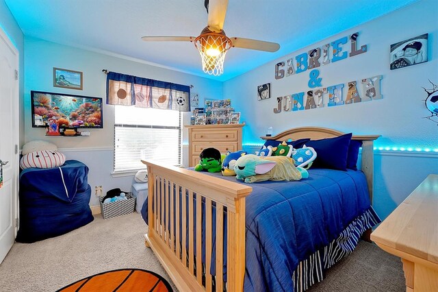 bedroom with ceiling fan and carpet