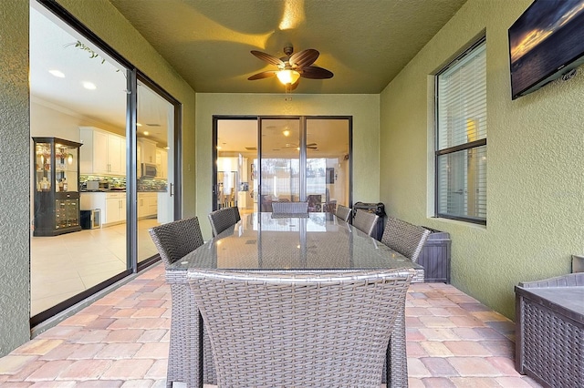 sunroom / solarium with ceiling fan