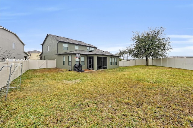 rear view of property with a sunroom and a lawn