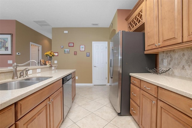 kitchen featuring tasteful backsplash, sink, stainless steel appliances, and light tile patterned flooring