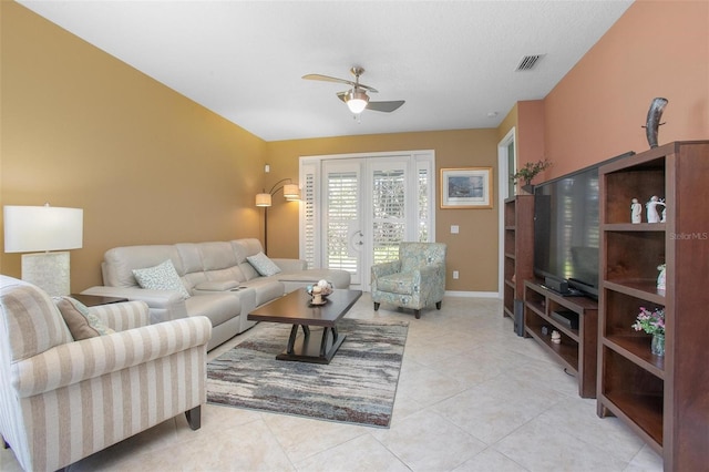 living room featuring french doors, ceiling fan, and light tile patterned floors