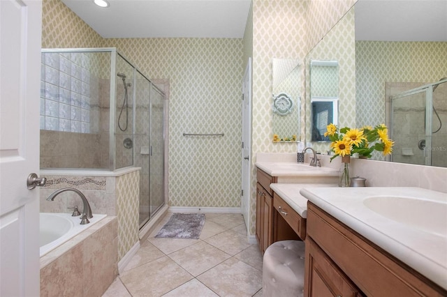 bathroom with tile patterned flooring, vanity, and separate shower and tub