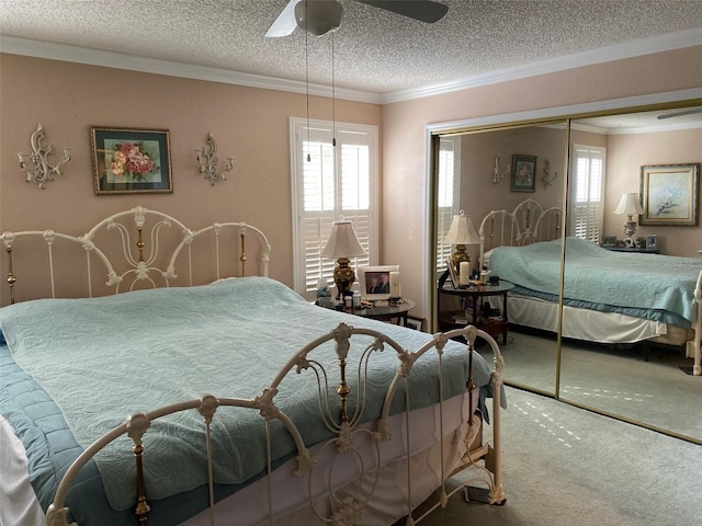 carpeted bedroom with multiple windows, ceiling fan, ornamental molding, and a closet