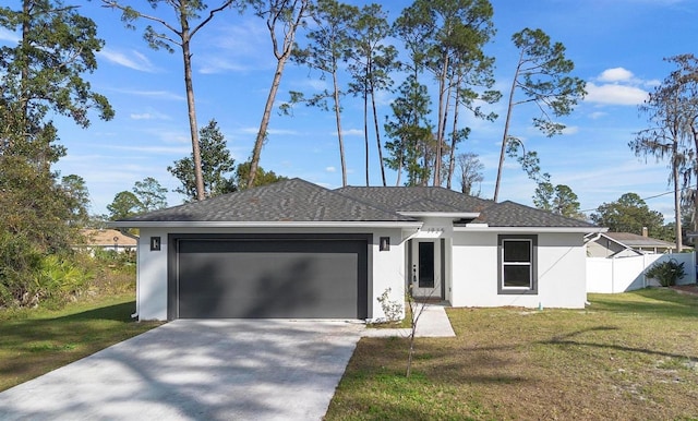 view of front of home featuring a garage and a front yard