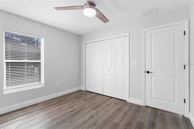 unfurnished bedroom featuring hardwood / wood-style flooring and ceiling fan